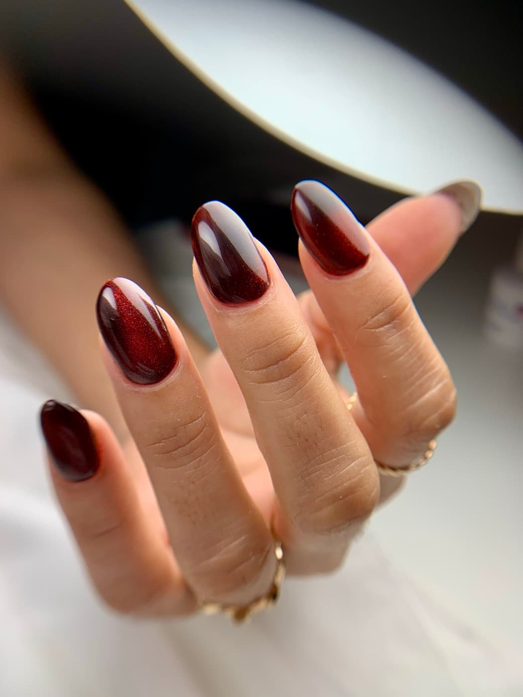 Almond nails in wine-red cat-eye